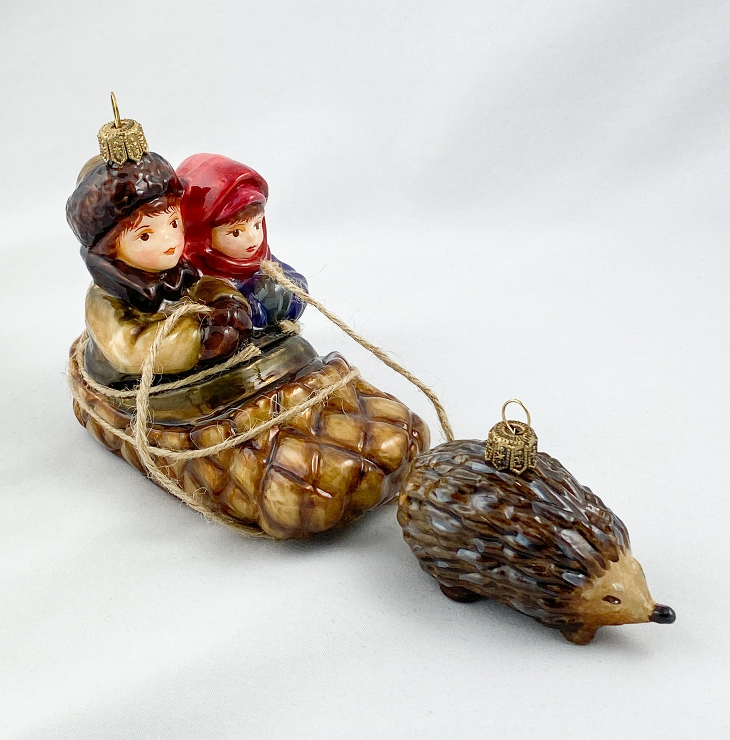 Two children in a hedgehog sleigh, set of 2, in a wooden box