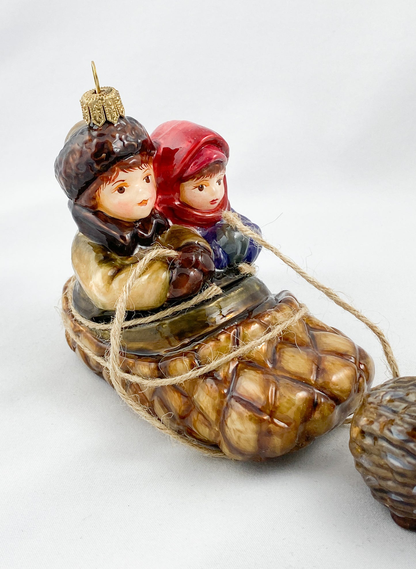 Two children in a hedgehog sleigh, set of 2, in a wooden box