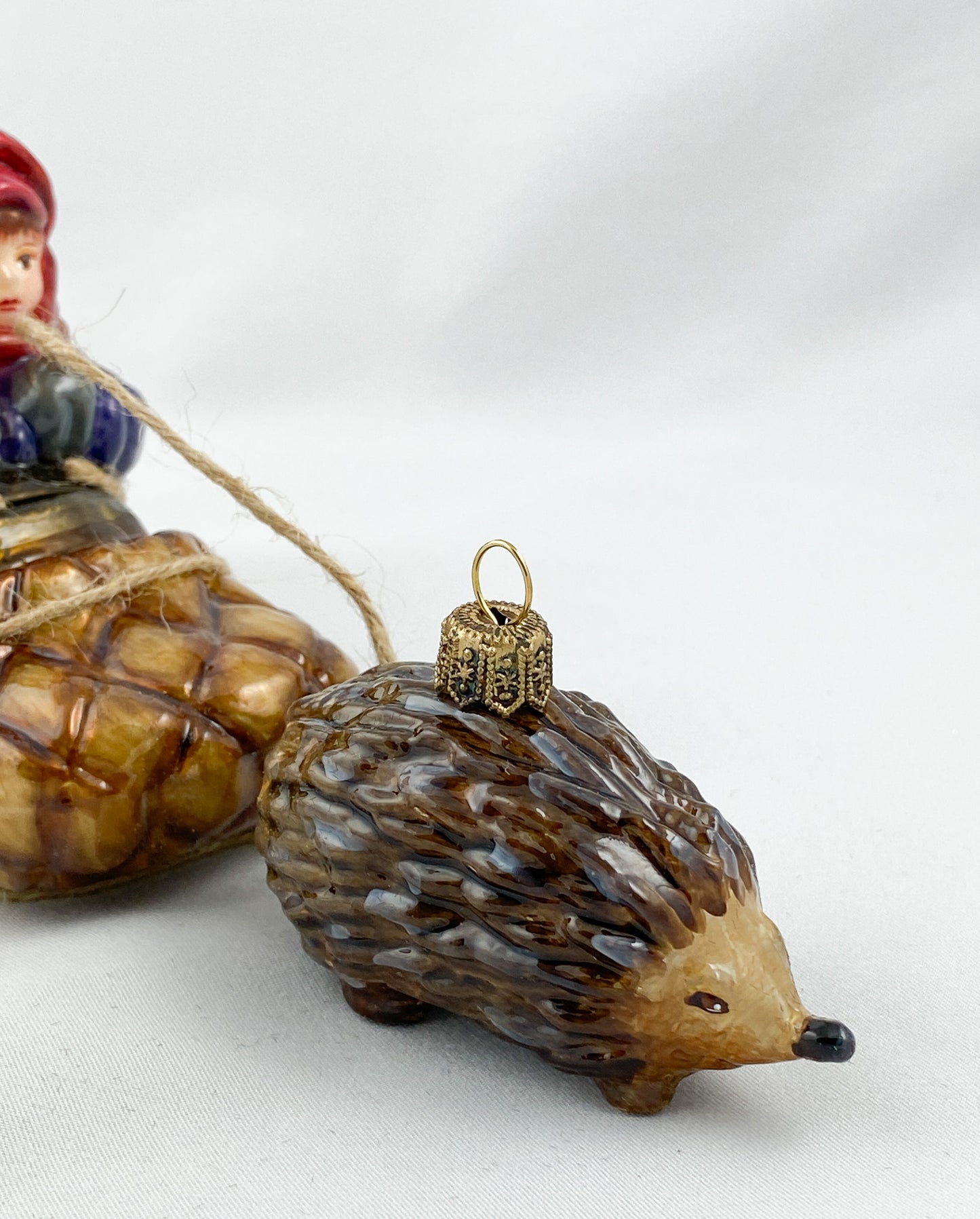 Two children in a hedgehog sleigh, set of 2, in a wooden box