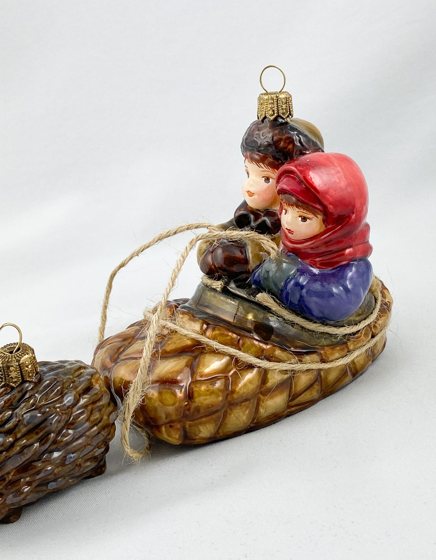 Two children in a hedgehog sleigh, set of 2, in a wooden box