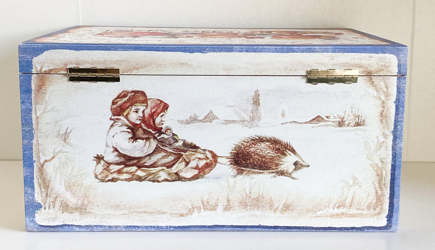 Two children in a hedgehog sleigh, set of 2, in a wooden box
