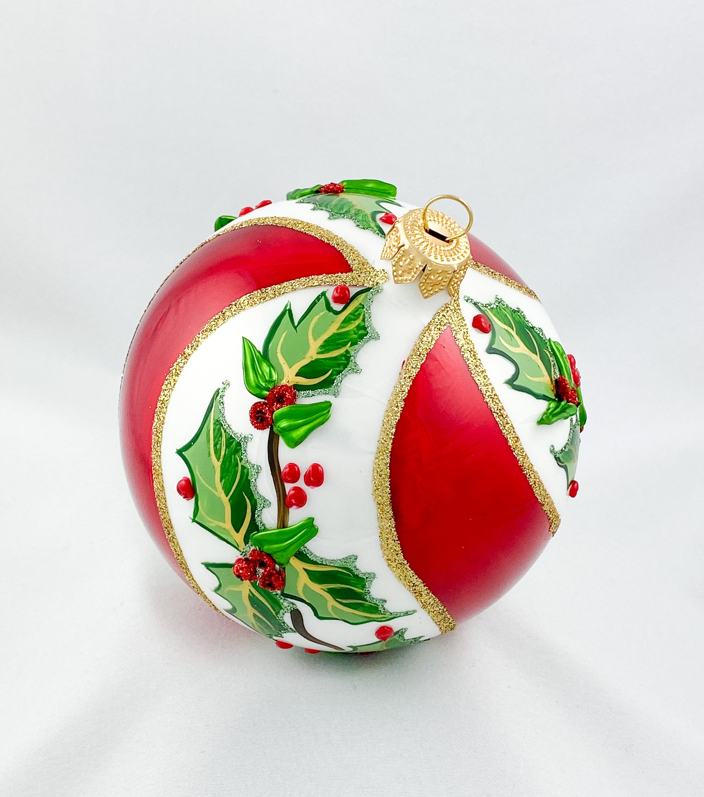 White red diagonally striped ball with holly decoration