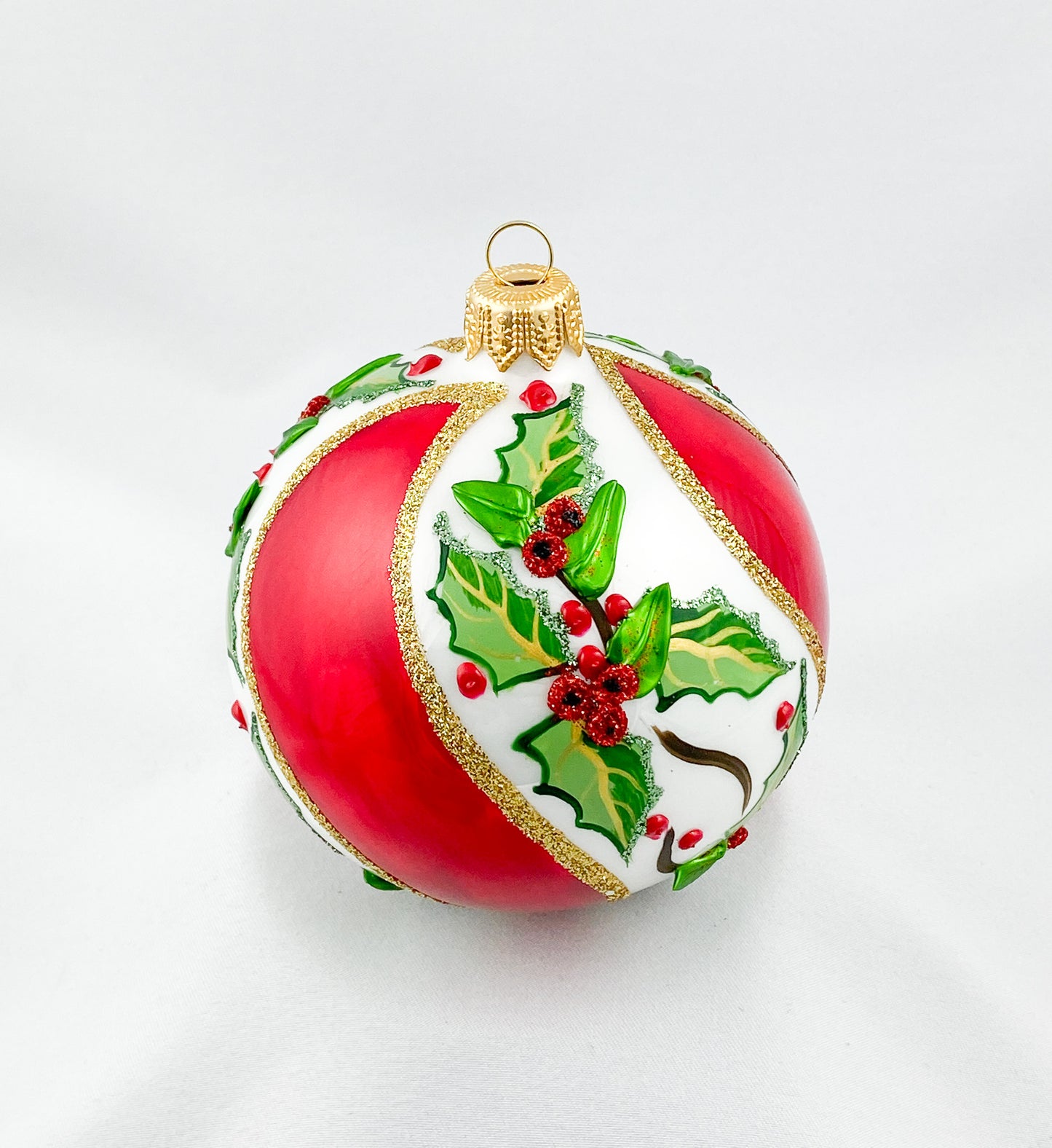 White red diagonally striped ball with holly decoration