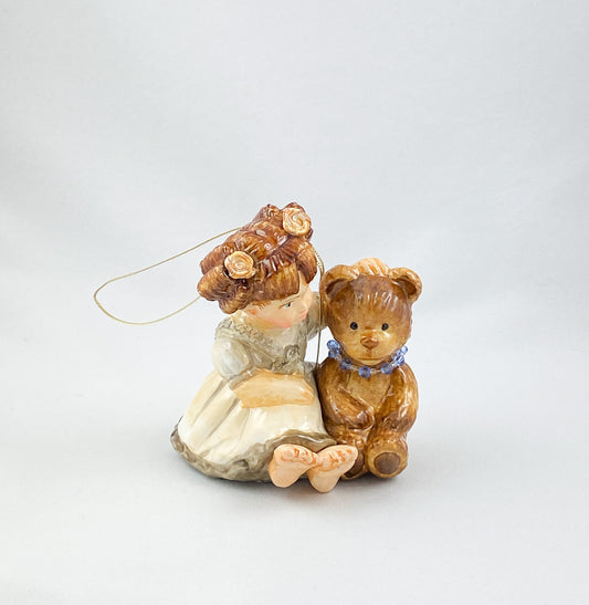 The little girl tells the teddy bear a story AtlasArt