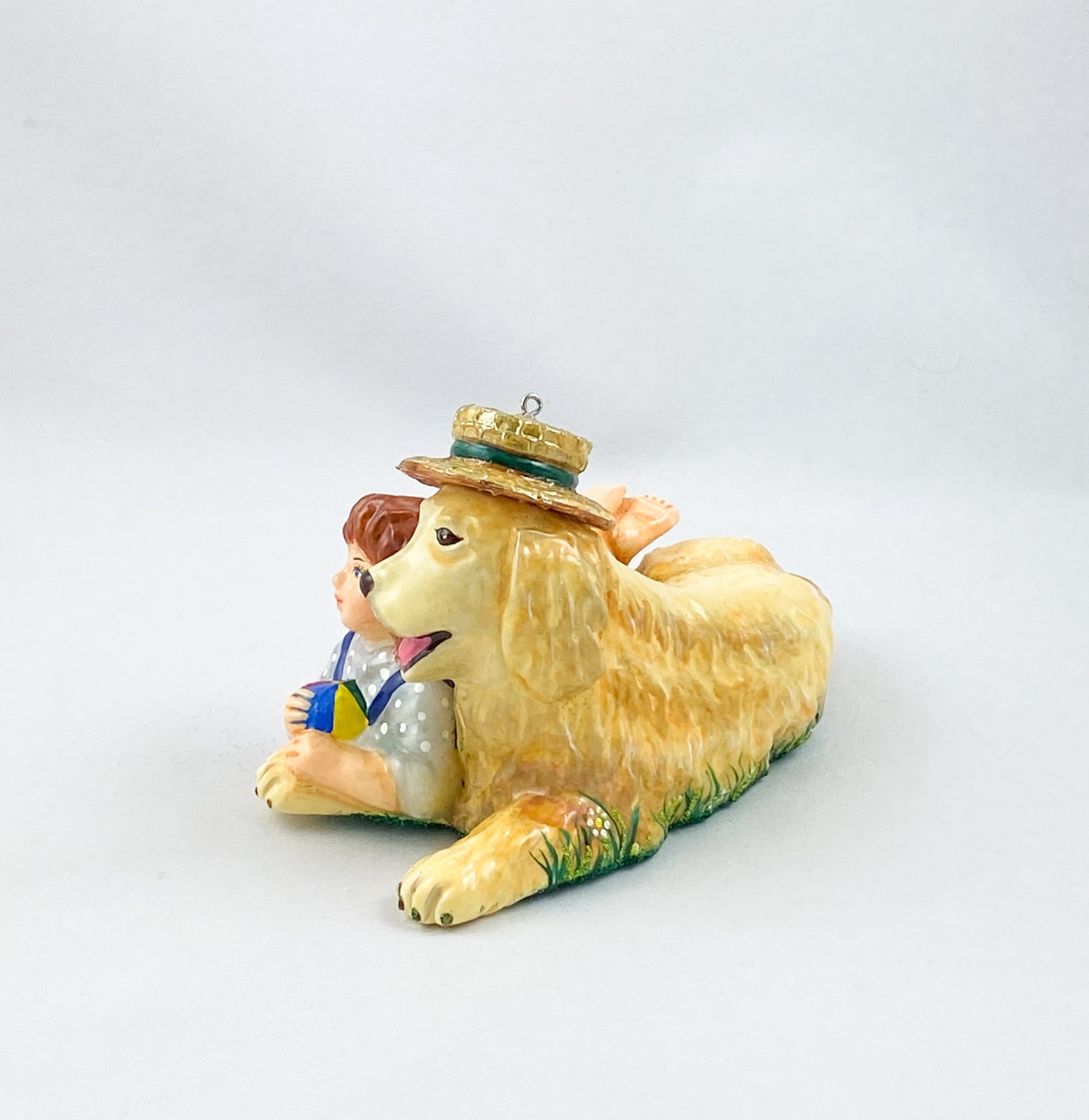 The girl is playing with the Golden Retriever in the summer meadow. AtlasArt