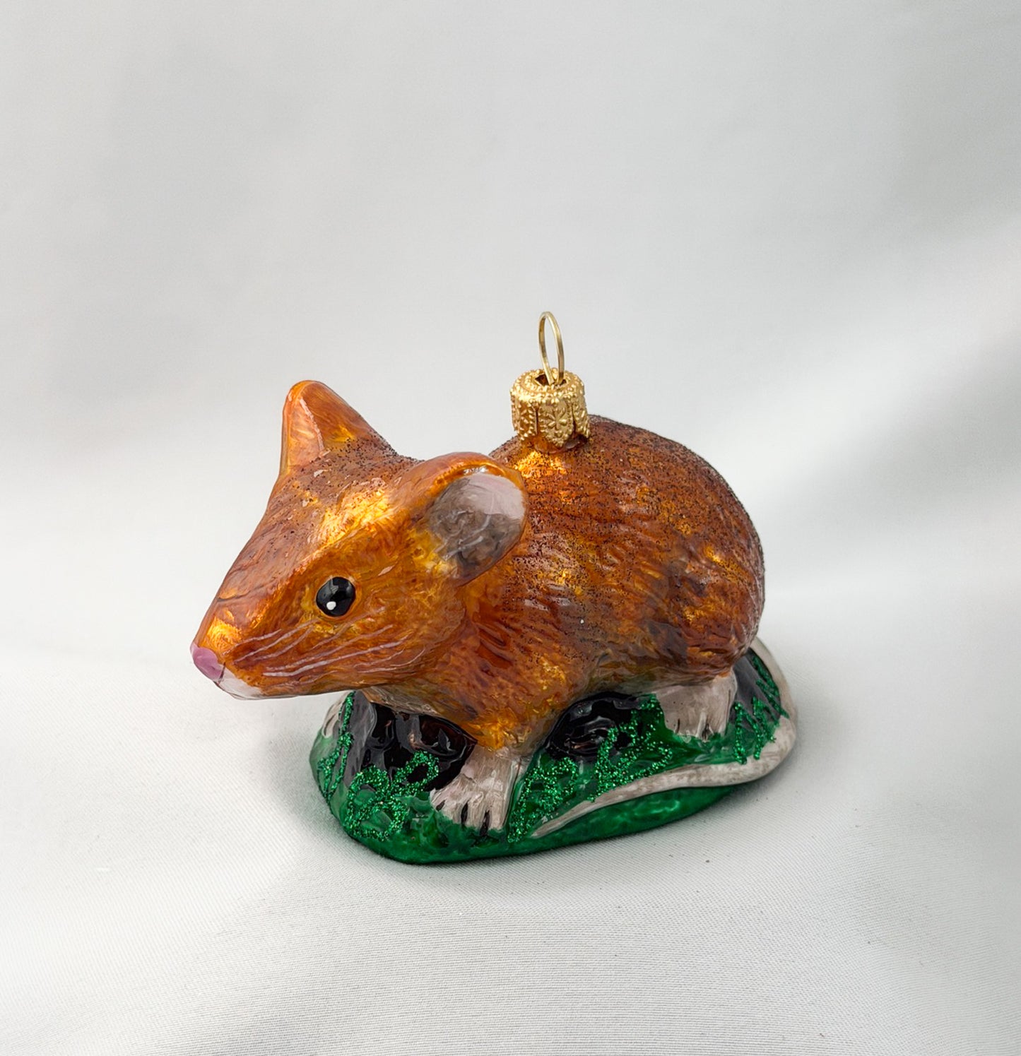 Brown dormouse hides in the grass