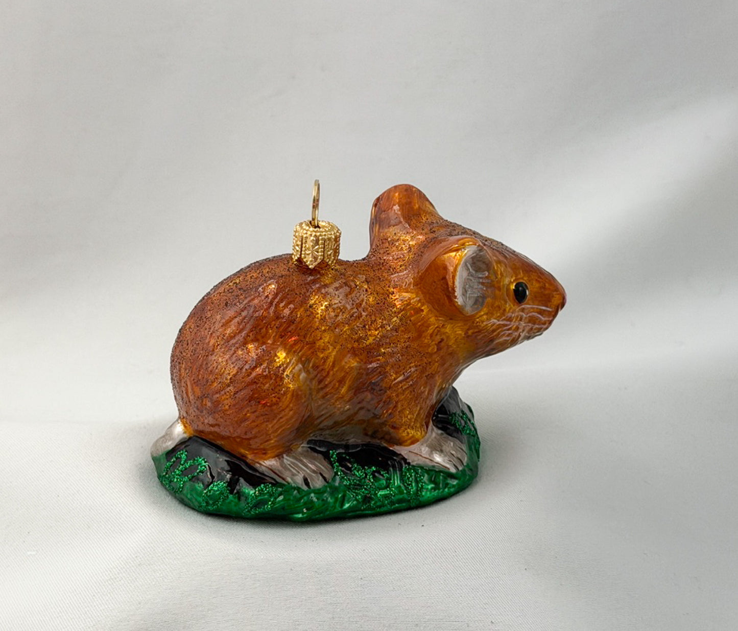 Brown dormouse hides in the grass
