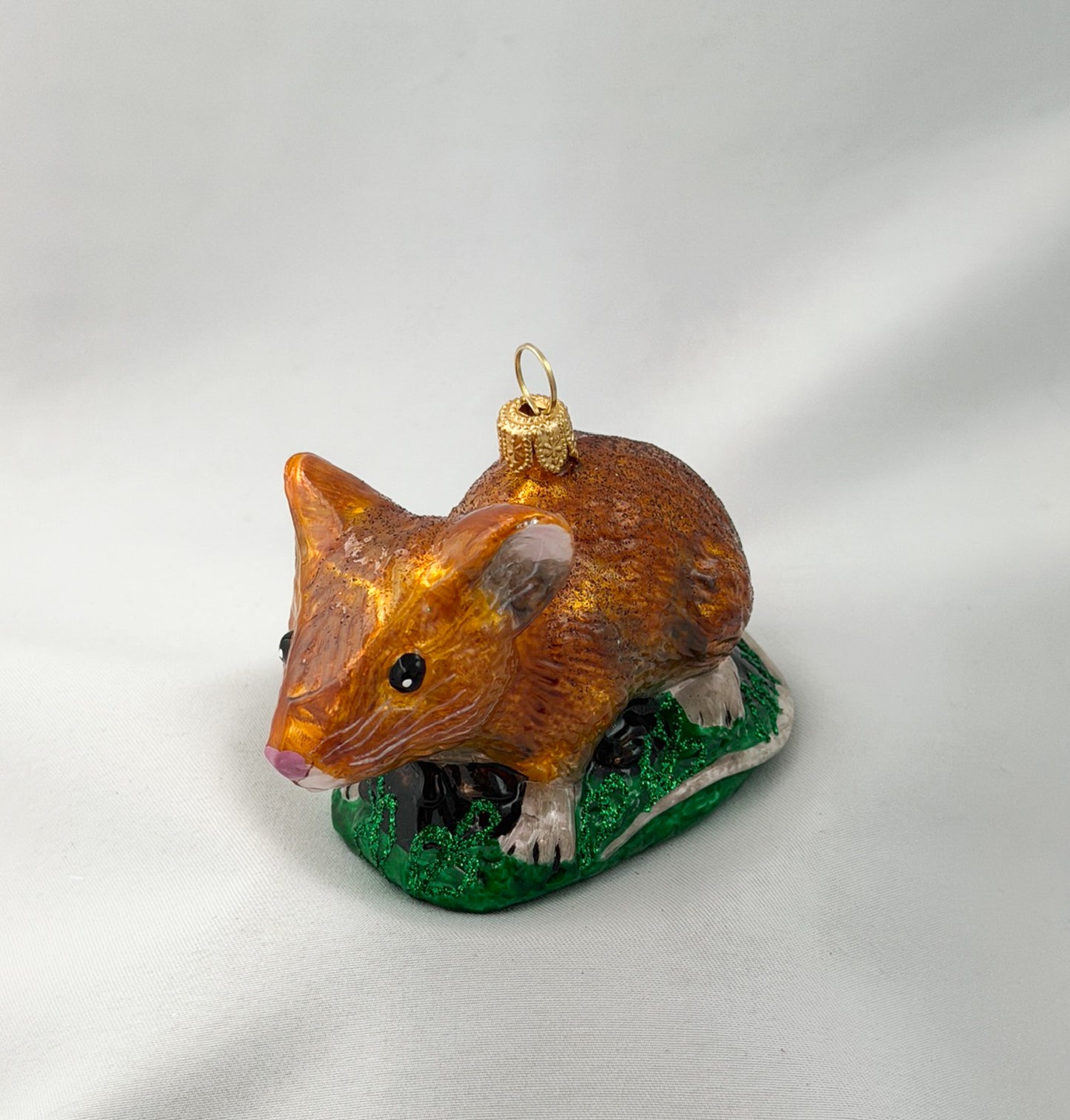 Brown dormouse hides in the grass
