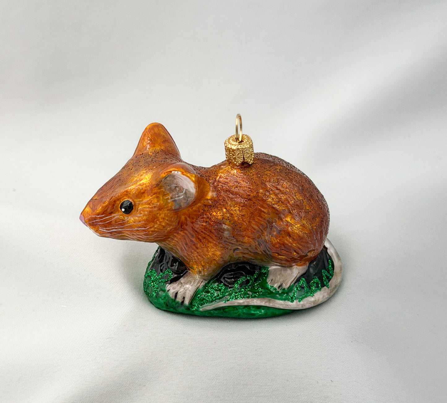 Brown dormouse hides in the grass