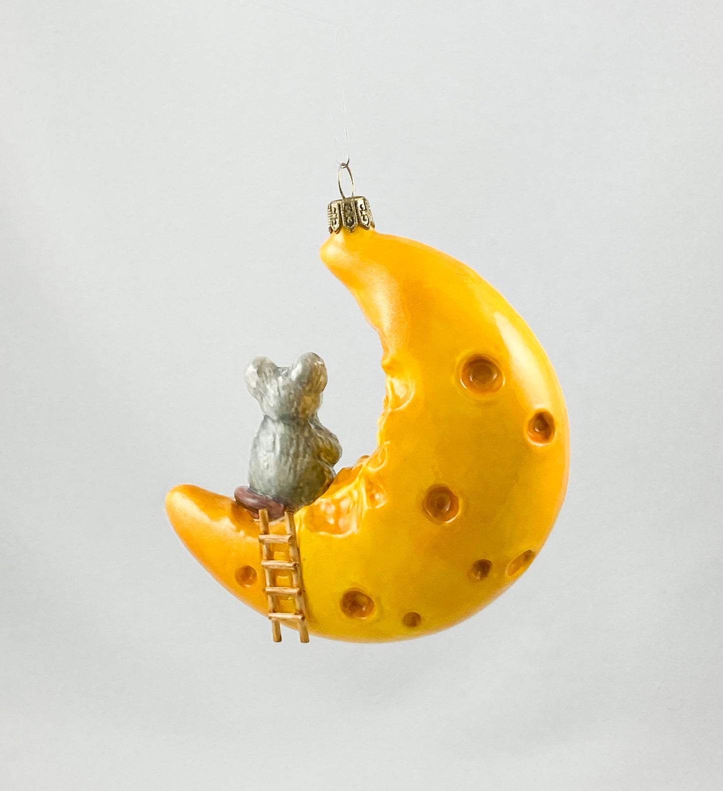 The mouse has made itself comfortable with a piece of cheese on the cheese crescent moon AtlasArt