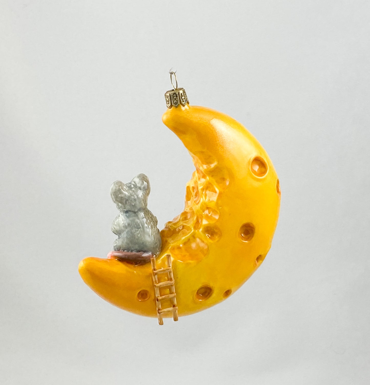 The mouse has made itself comfortable with a piece of cheese on the cheese crescent moon AtlasArt