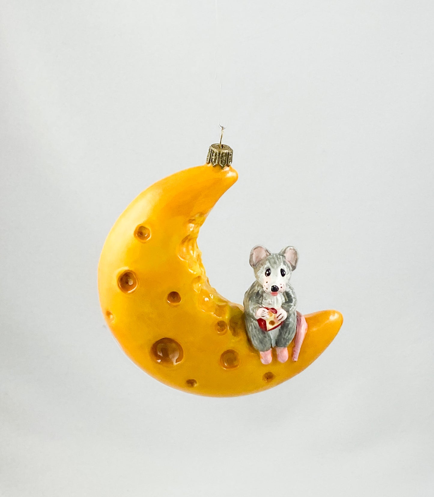 The mouse has made itself comfortable with a piece of cheese on the cheese crescent moon AtlasArt