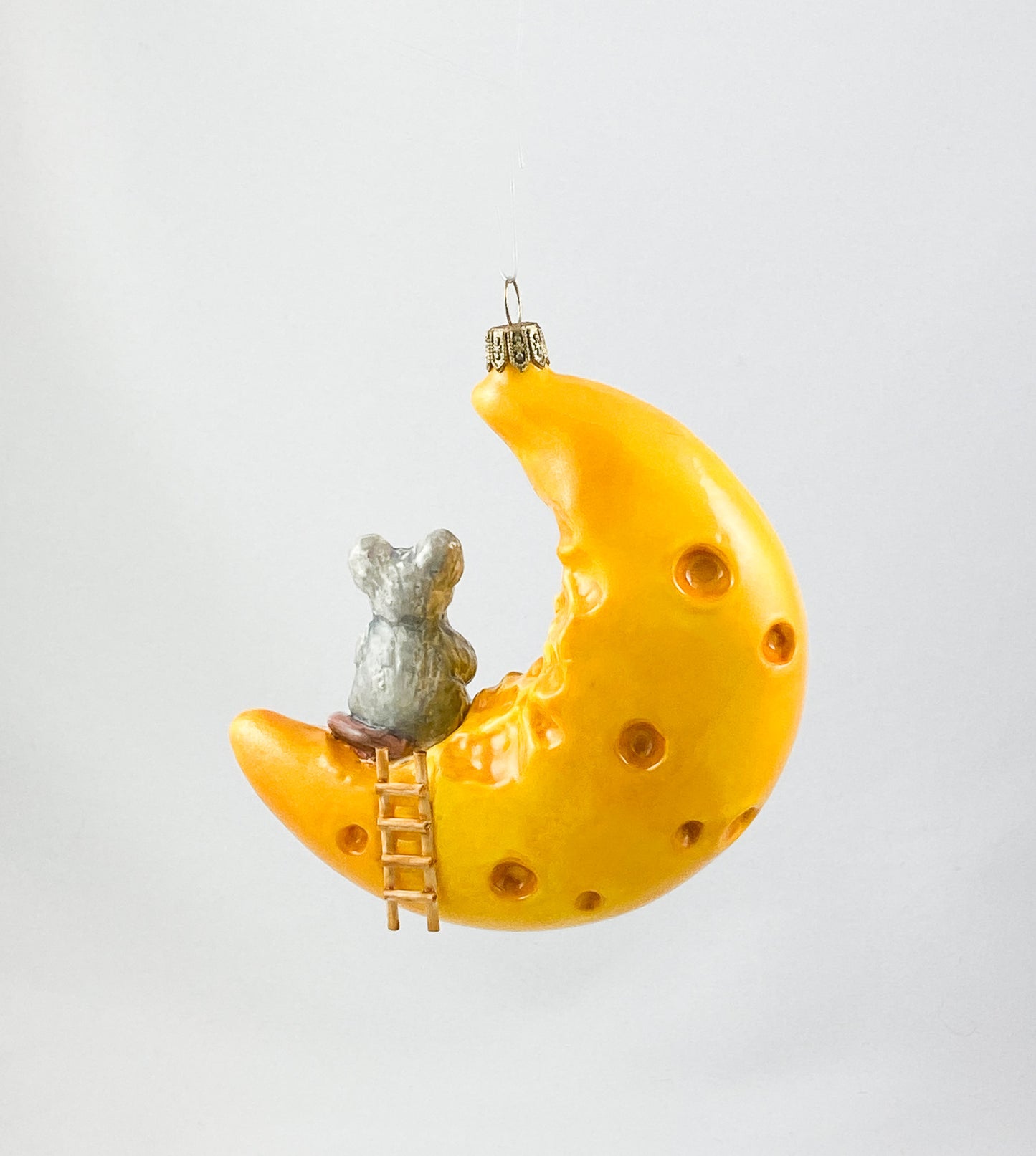 The mouse has made itself comfortable with a piece of cheese on the cheese crescent moon AtlasArt