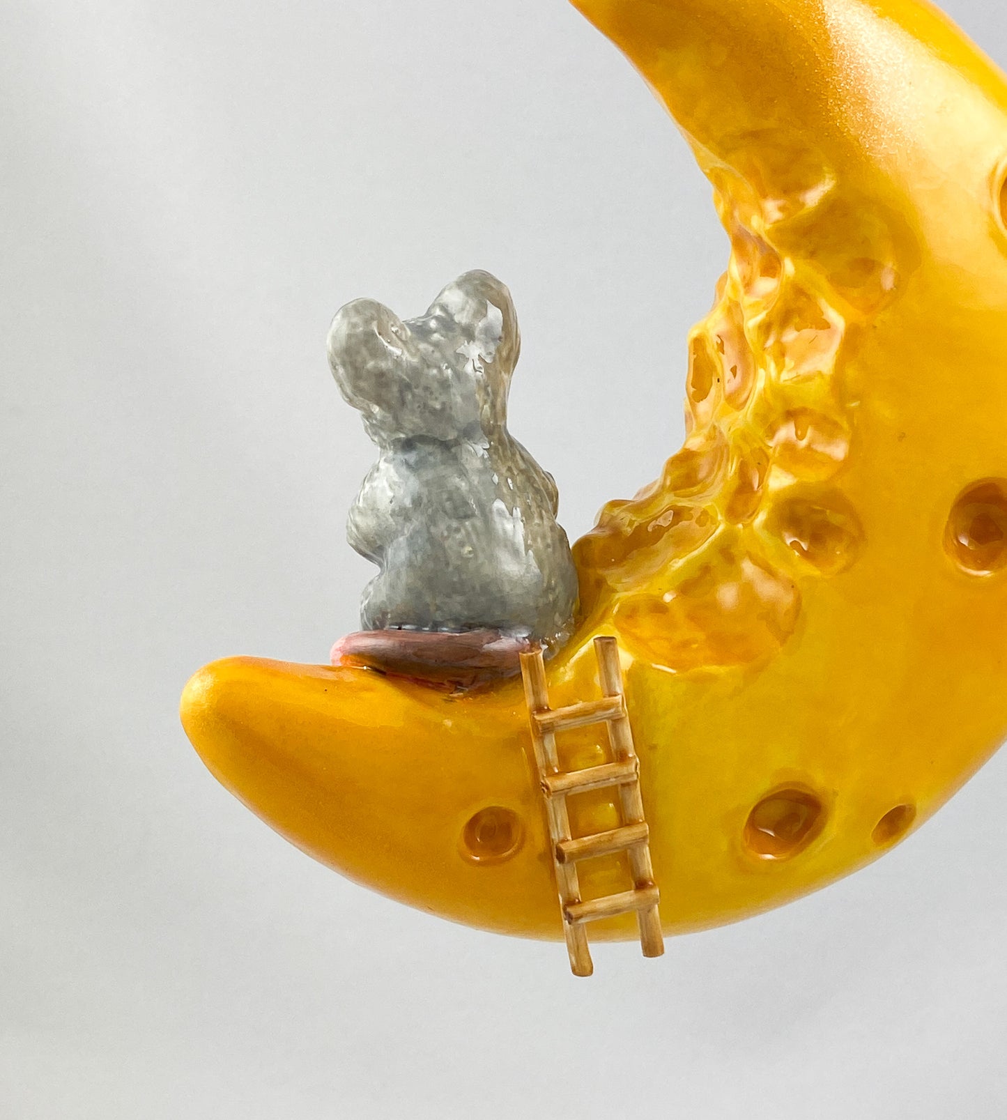 The mouse has made itself comfortable with a piece of cheese on the cheese crescent moon AtlasArt