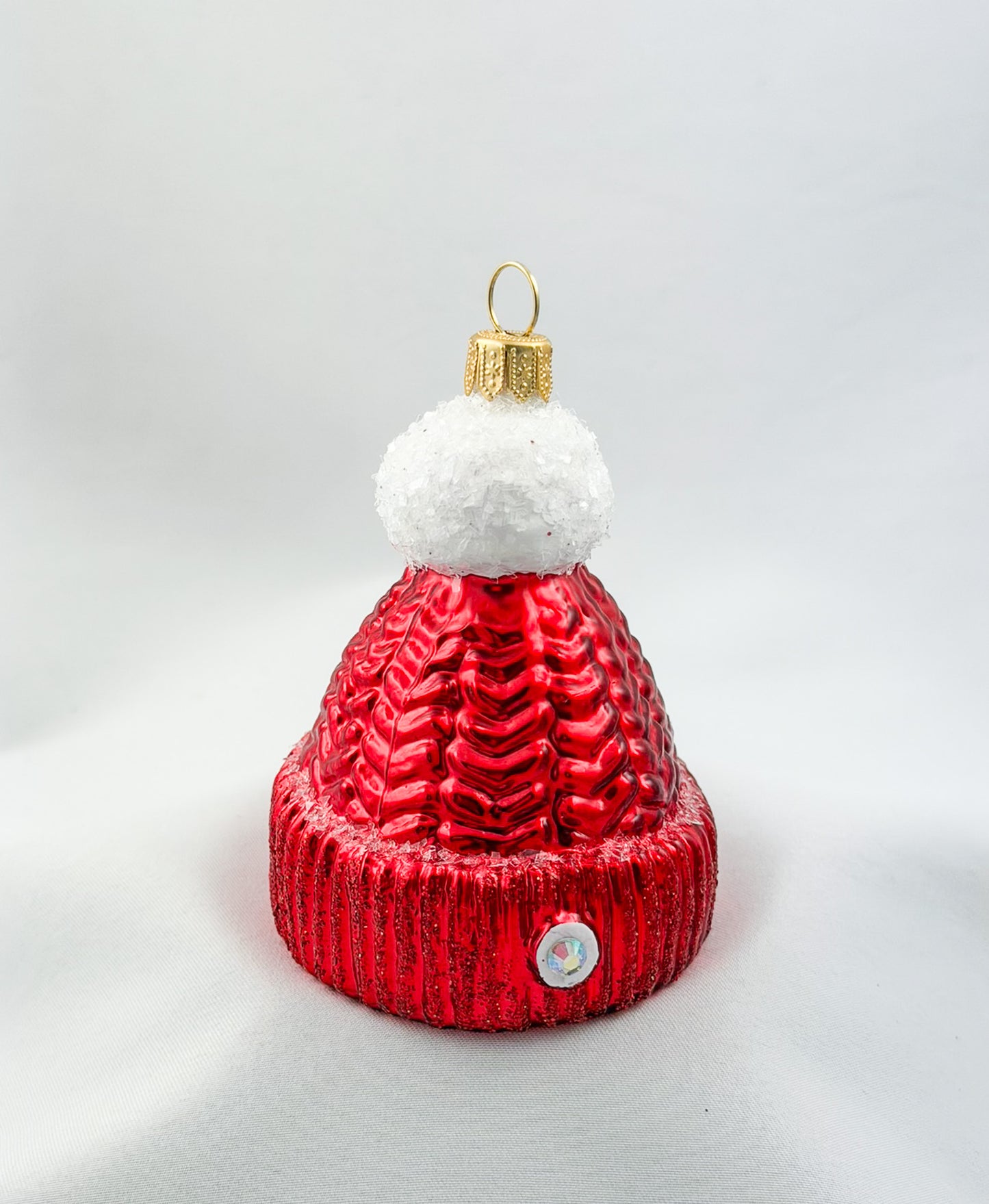 Red knitted hat with white pompom