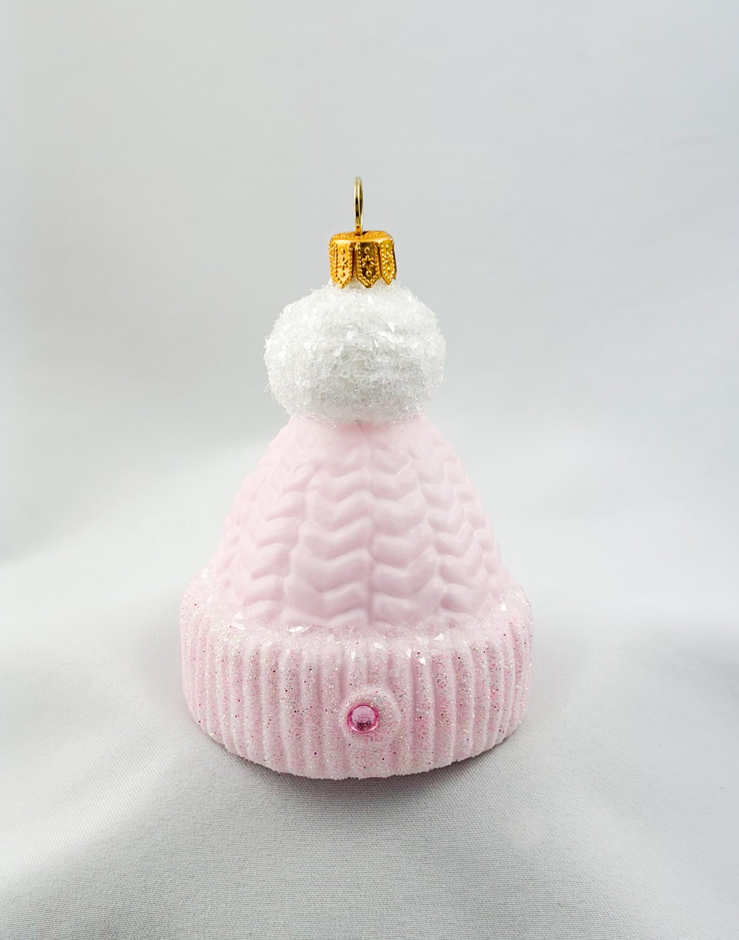 Pink knit beanie with white pompom