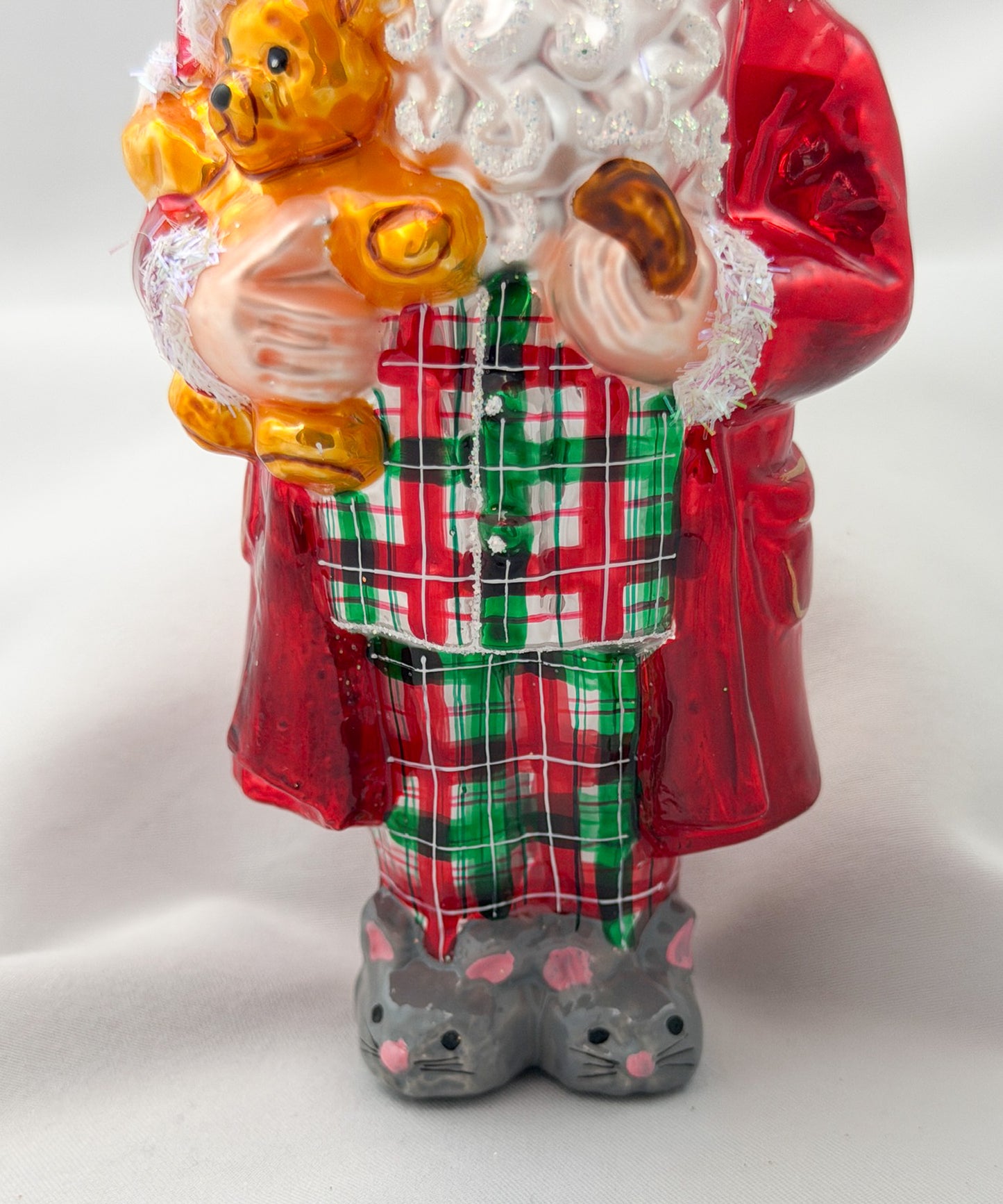 Santa has made himself comfortable with the teddy bear in mouse slippers and pajamas