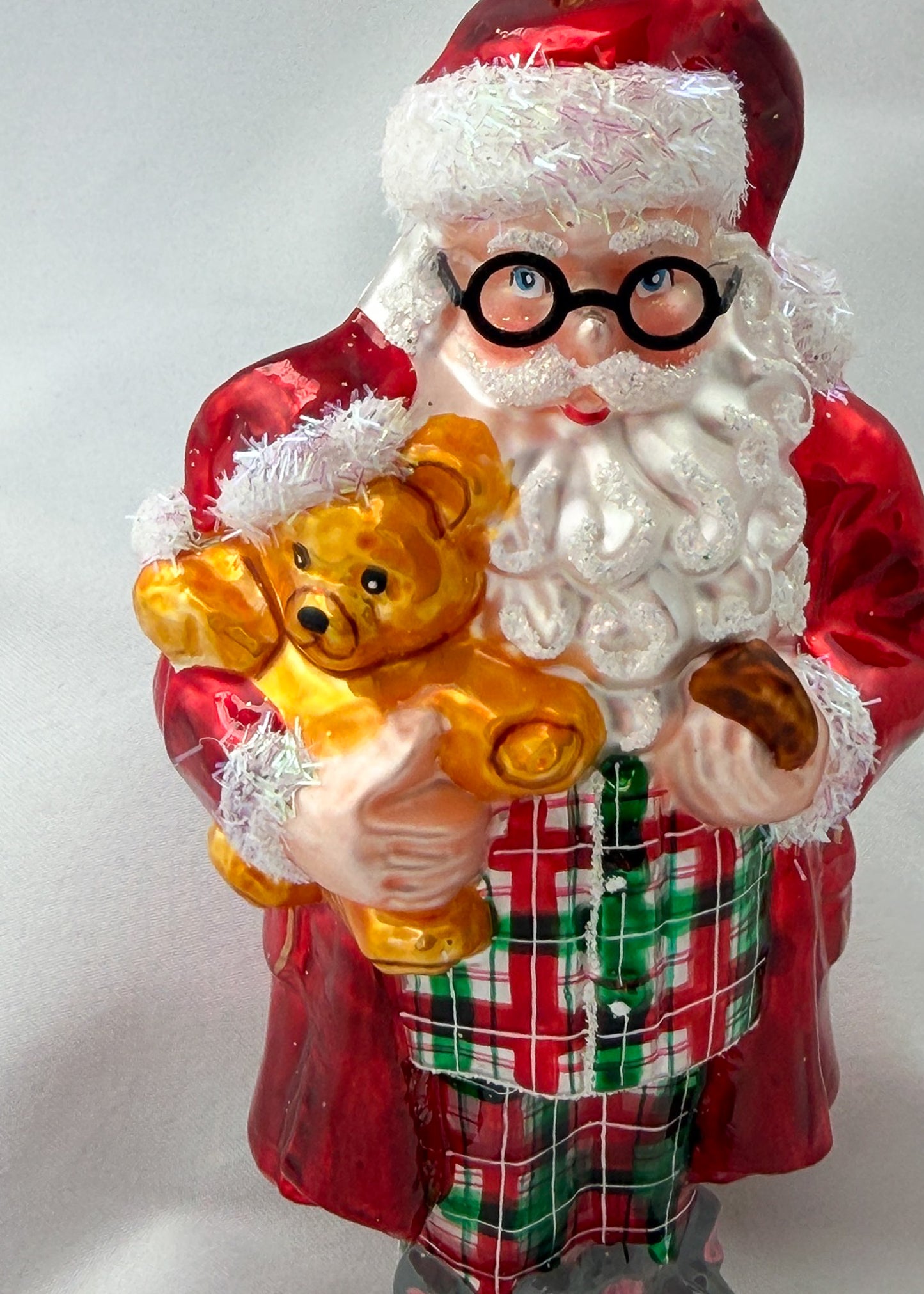 Santa has made himself comfortable with the teddy bear in mouse slippers and pajamas