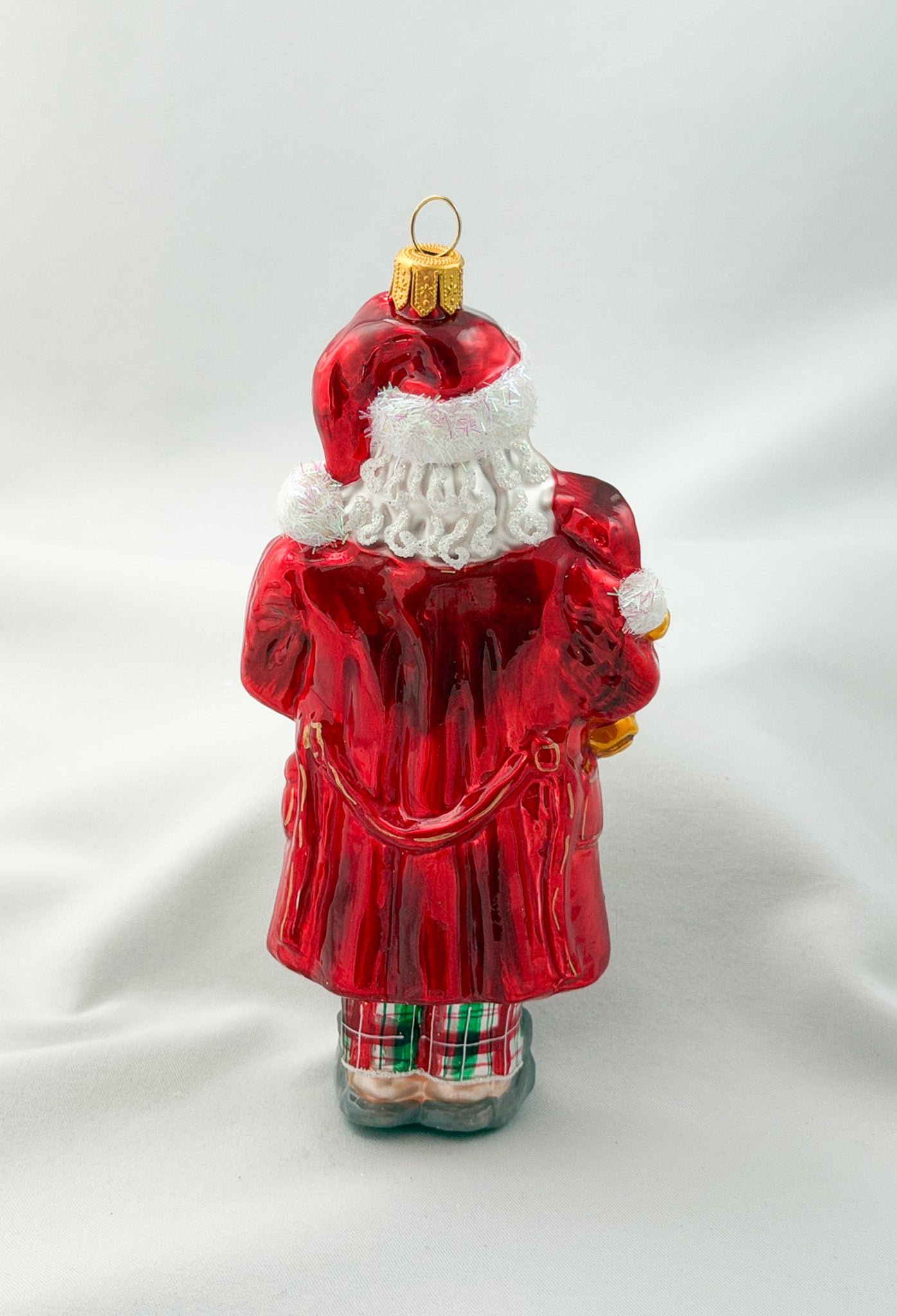 Santa has made himself comfortable with the teddy bear in mouse slippers and pajamas