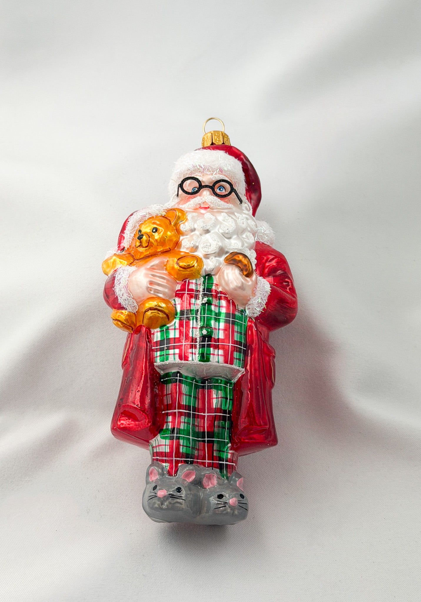 Santa has made himself comfortable with the teddy bear in mouse slippers and pajamas