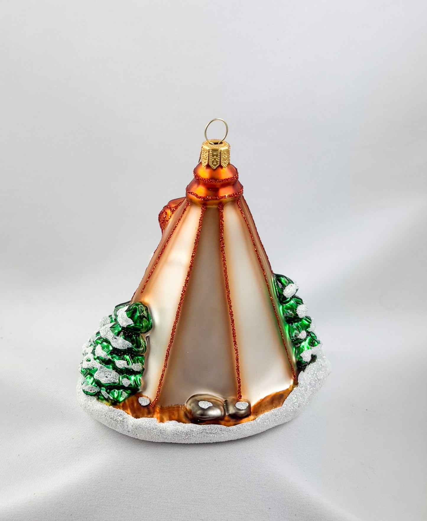 Santa is sitting comfortably in his tent by the campfire.