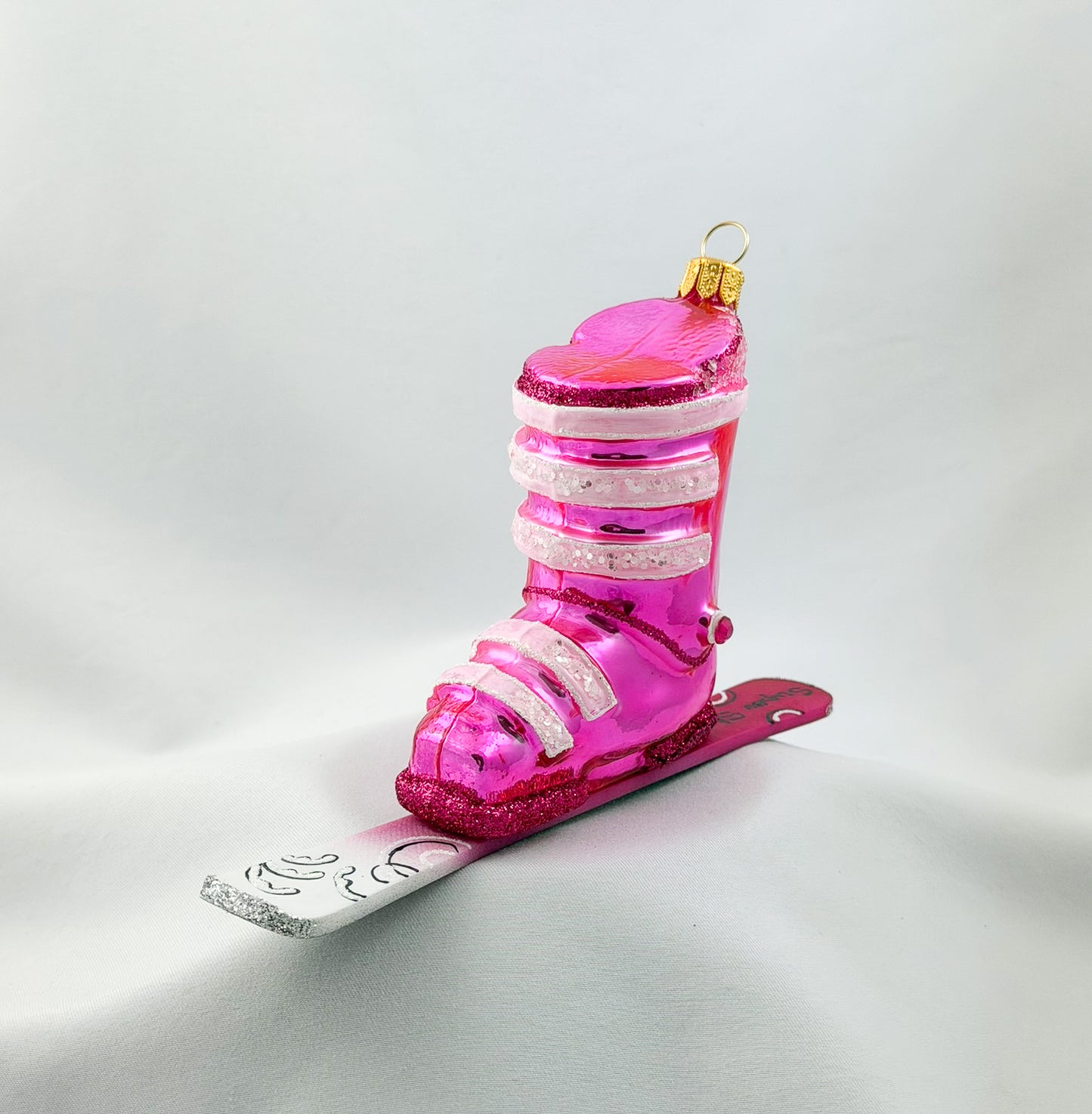 Pink ski boot with skis