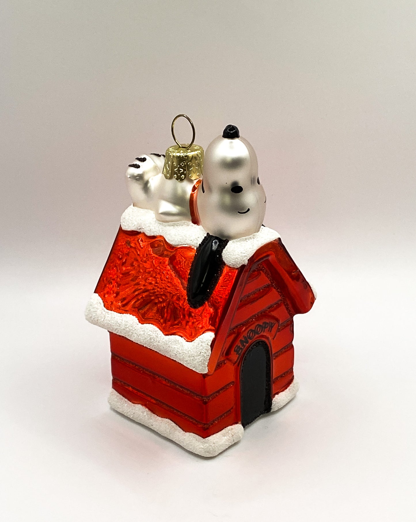 Snoopy lying on his doghouse