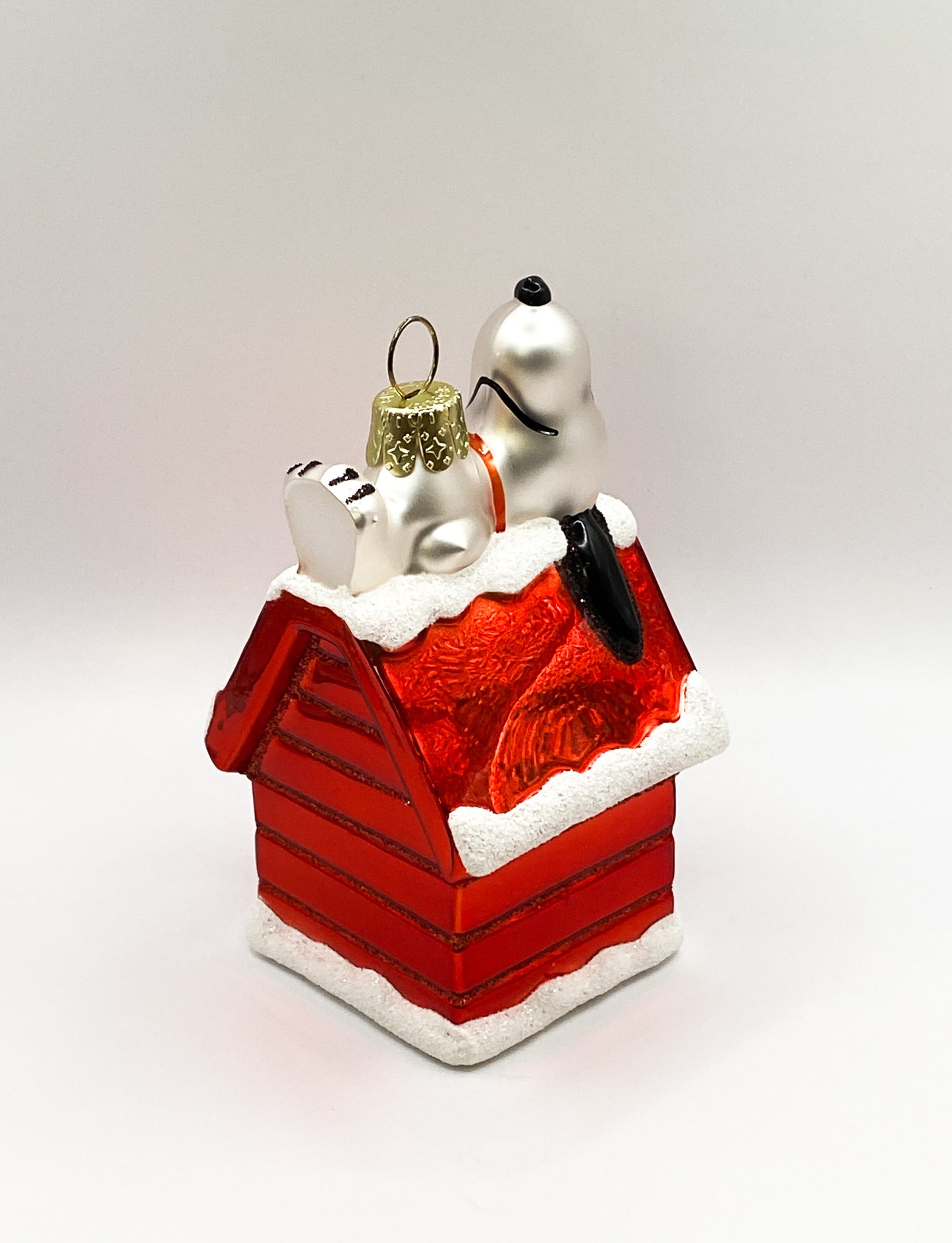 Snoopy lying on his doghouse