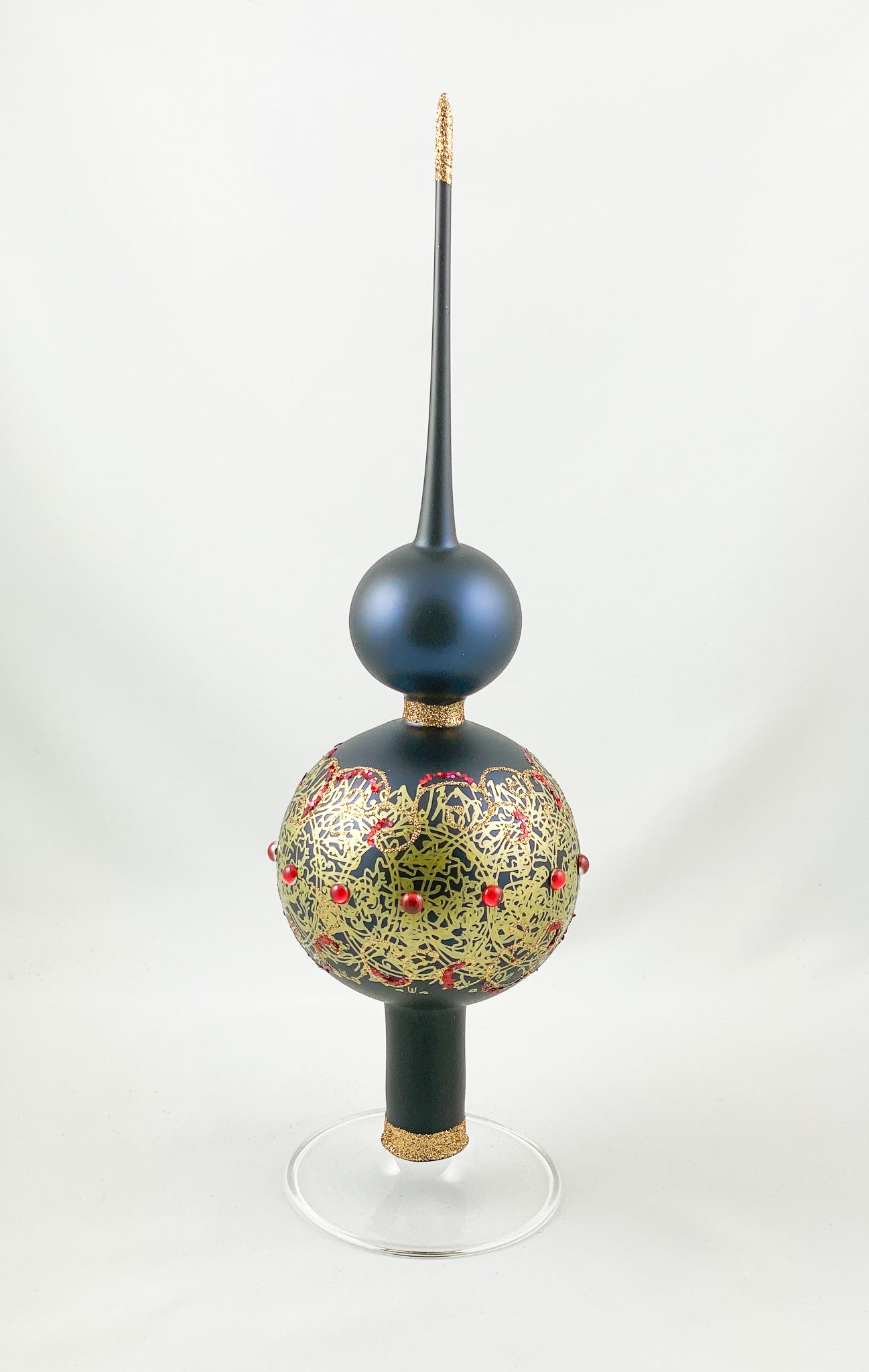 Dark blue tree topper with golden decoration and red gemstones