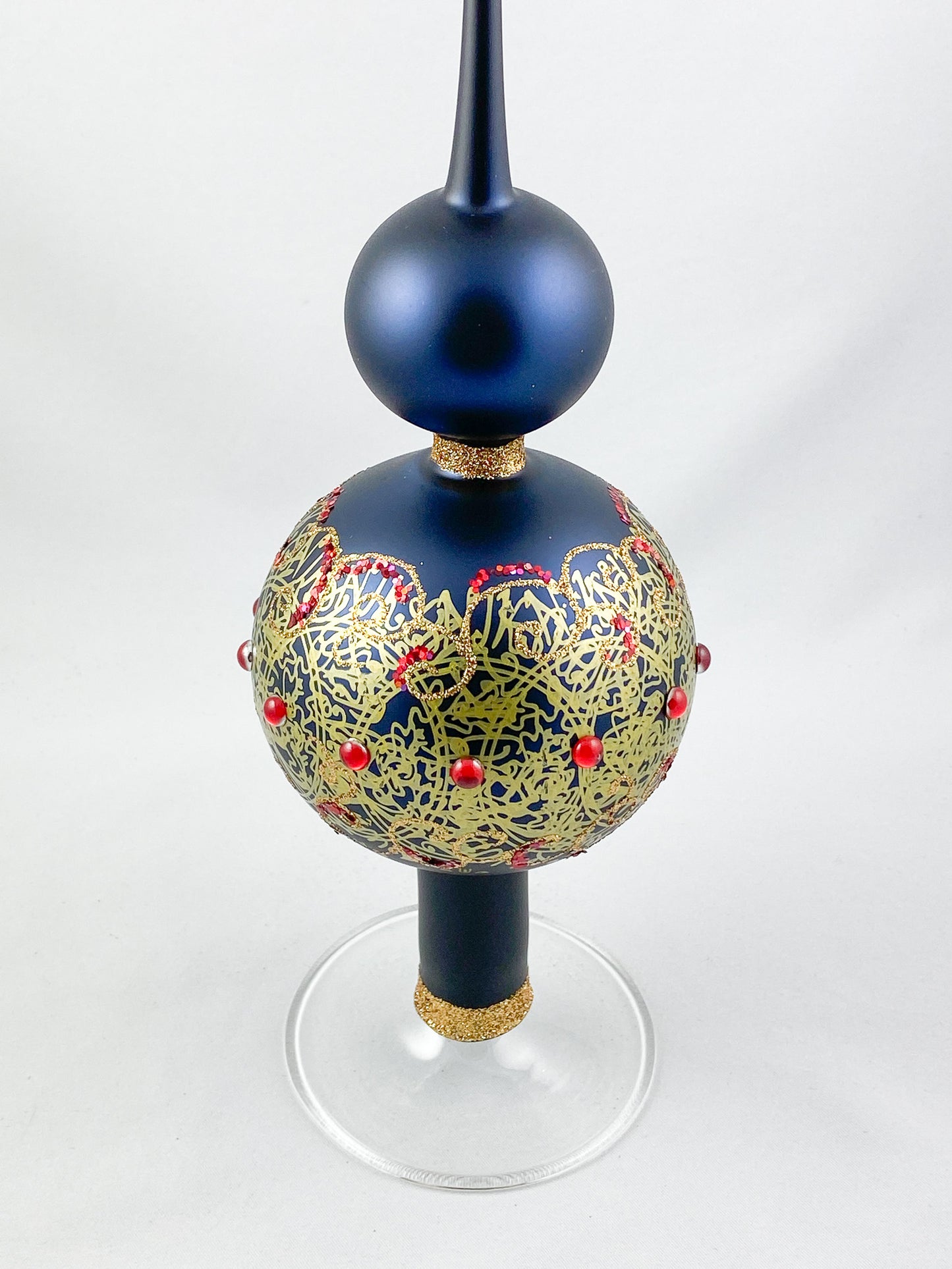 Dark blue tree topper with golden decoration and red gemstones