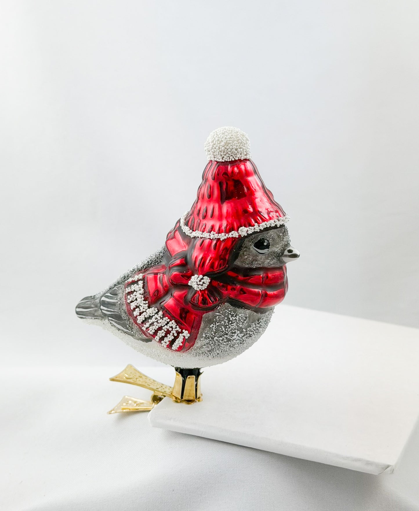 Mountain tit with red cap and red scarf on clip