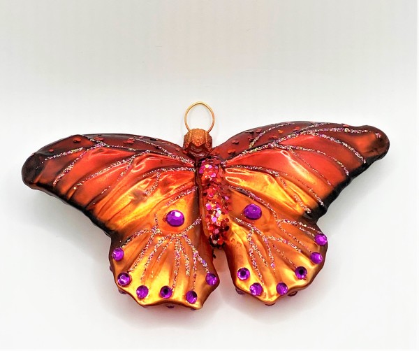 Rostroter Schmetterling mit violetten Schmucksteinen