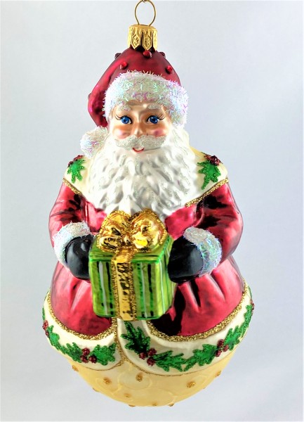 Weihnachtsmann auf Kugel und Ilex-Dekor am Mantel