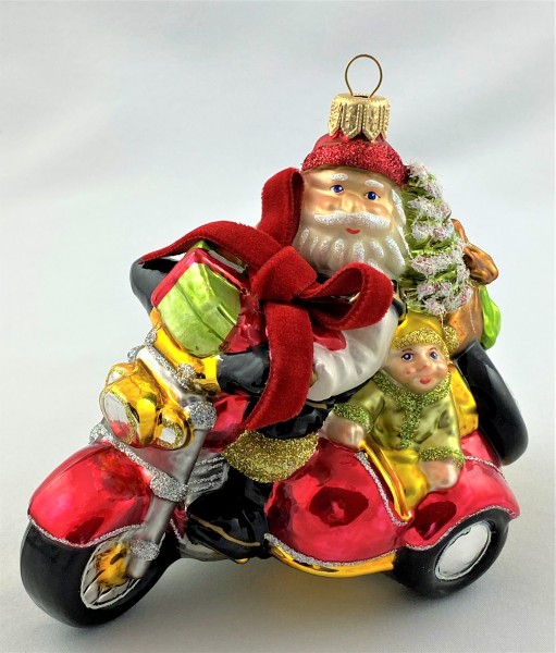 Weihnachtsmann und Wichtel bringen die Geschenke mit dem Seitenwagen-Motorrad