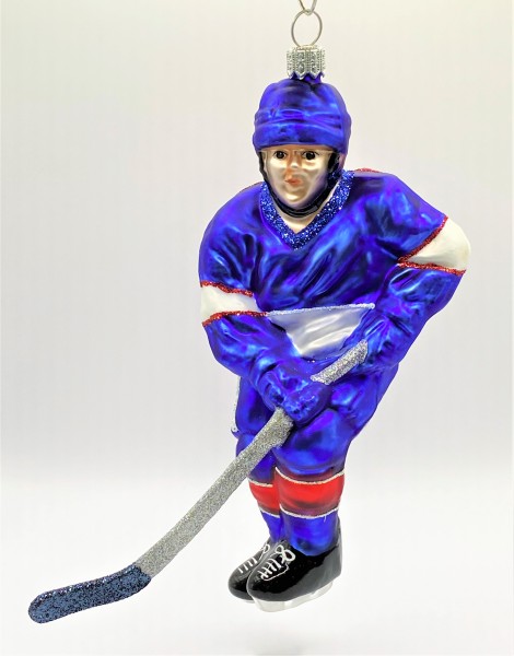 Schweizer Eishockey Spieler in blauem Trikot mit weissen und roten Streifen