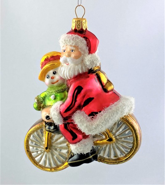 Weihnachtsmann und Schneemann fahren gemeinsam Fahrrad