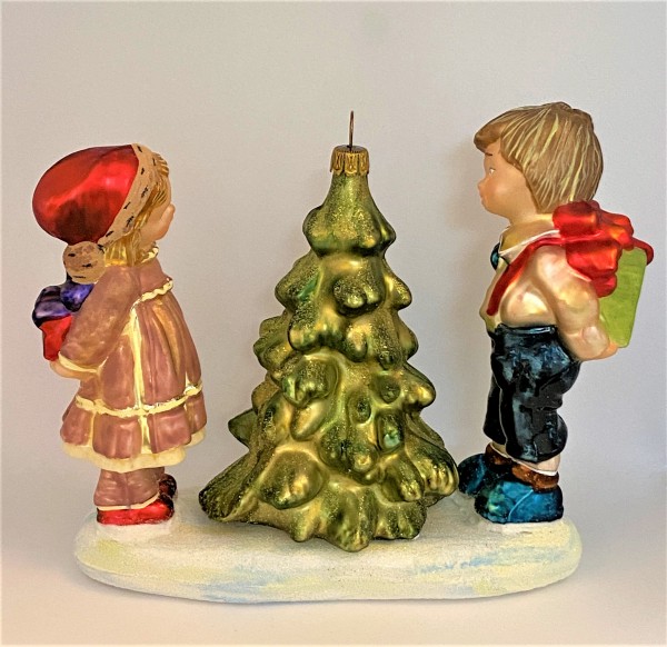 Das Mädchen im rosa Kleid und der Junge in der dunklen Hose bewundern den Weihnachtsbaum, KOMOZJA MO